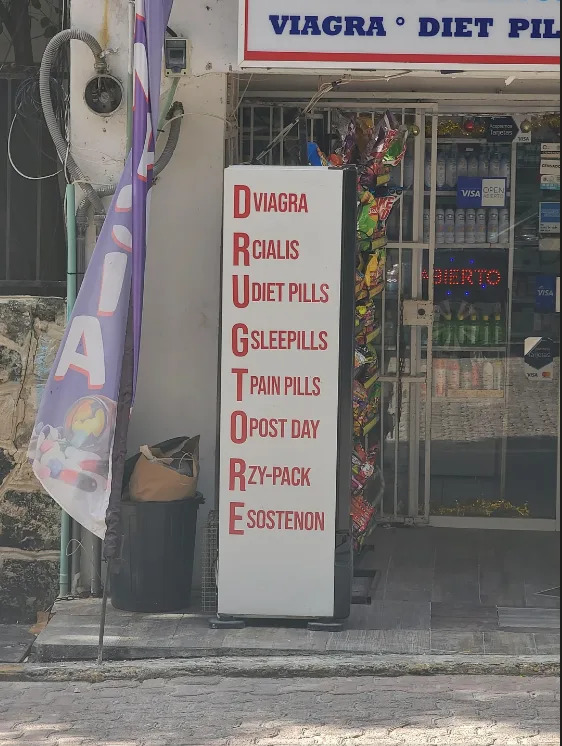 Signo fuera de una tienda listas de productos: Viagra, Cialis, tabletas de dieta, tabletas para dormir, tabletas para el dolor, post-día, Z-packs y Sostenon. Parece que se encuentran en un acrónimo de la palabra "farmacia," pero ninguna de las primeras letras coincide
